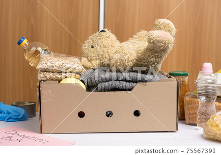 cardboard box with food and things to help those in need 75567391