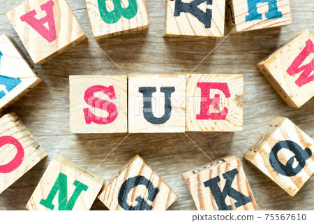 Alphabet letter block in word sue with another on wood background 75567610