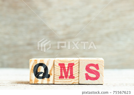 Alphabet letter block in word QMS (abbreviation of quality management system) on wood background Alphabet letter block in word QMS (abbreviation of quality management system) on wood background 75567623