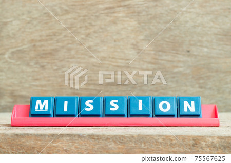 Tile alphabet letter with word mission in red color rack on wood background 75567625