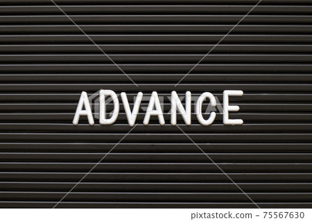 White alphabet in word advance on black color felt letter board background White alphabet in word advance on black color felt letter board background 75567630