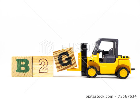 Toy forklift hold letter block G to complete word b2g (abbreviation of business to government) on wood background Toy forklift hold letter block G to complete word b2g (abbreviation of business to government) on wood background 75567634