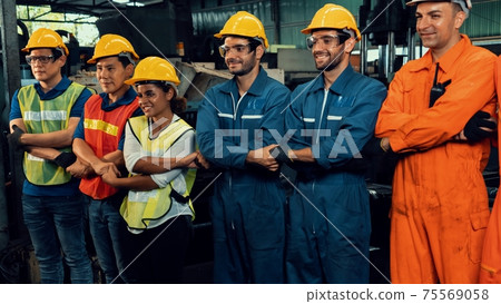 Skillful worker stand together showing teamwork in the factory . Skillful worker stand together showing teamwork in the factory . 75569058