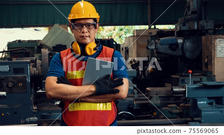 Young skillful factory worker or engineer close up portrait in factory 75569065