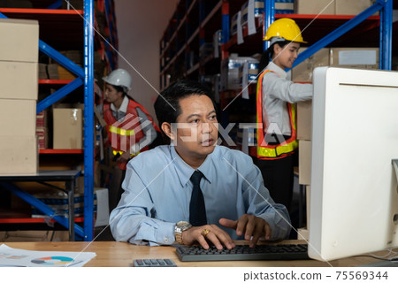 Warehouse manager and worker working in the storehouse 75569344