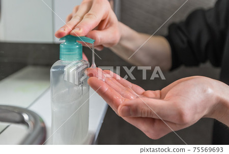 close up. man pressing the dispenser with bactericidal soap. 75569693