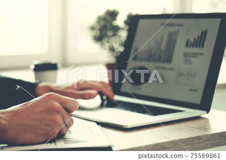 close up. business man works analyzing financial tables . 75569861