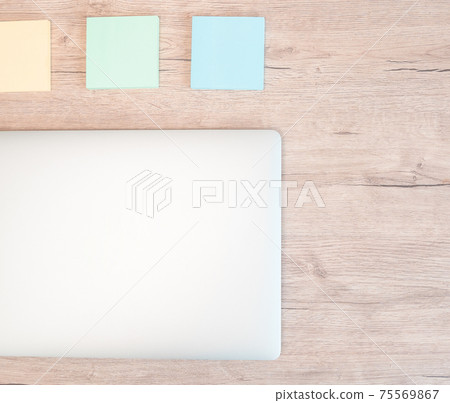 close up. sticky notes and a white laptop on the table. close up. sticky notes and a white laptop on the table. 75569867