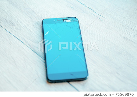 close up. cracked, damaged, broken smartphone LCD screen close up. cracked, damaged, broken smartphone LCD screen 75569870
