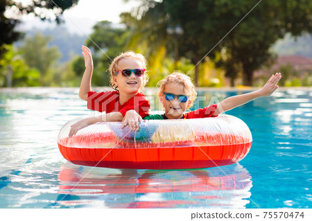 Kids in swimming pool. Life jacket for child. Kids in swimming pool. Life jacket for child. 75570474