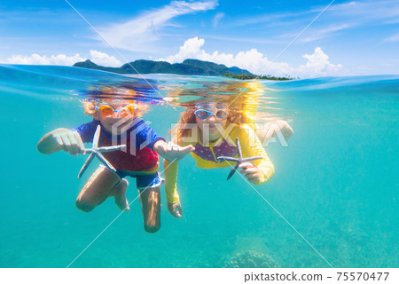 Child snorkeling. Kids underwater. Beach and sea. Child snorkeling. Kids underwater. Beach and sea. 75570477