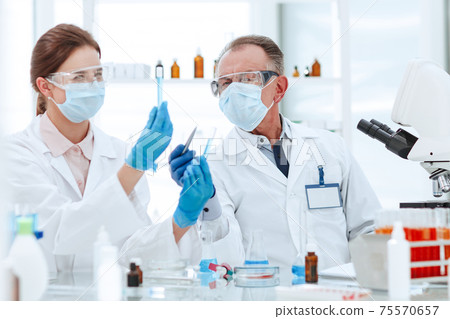 medical laboratory staff discussing the test results . medical laboratory staff discussing the test results . 75570657