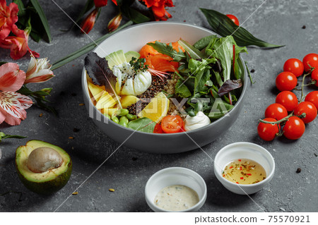 fresh healthy light breakfast, business lunch. Breakfast with poached egg, buckwheat, red fish, fresh salad, cucumbers, business lunch concept 75570921