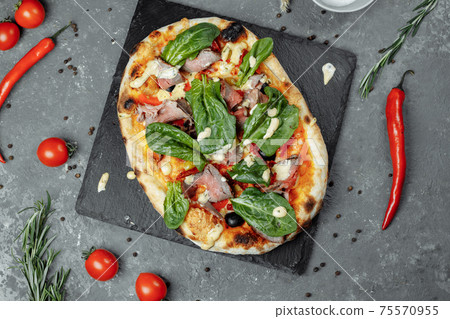 Meat Italian pizza with roast beef, steak slices, melted cheese, with olive slices and cheddar cheese. Close up, macro. Pizza time concept Meat Italian pizza with roast beef, steak slices, melted cheese, with olive slices and cheddar cheese. Close up, macro. Pizza time concept 75570955