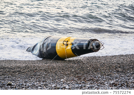 sea buoy washed ashore after a storm sea buoy washed ashore after a storm 75572274