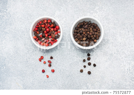 Pepper peas black and red in plates, gray concrete background, copy space. 75572877