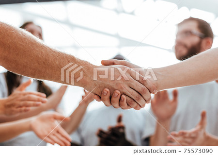 close up. handshake of two students on the background of the st 75573090