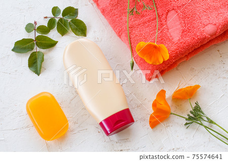 Towel and women cosmetics on a white background. Towel and women cosmetics on a white background. 75574641