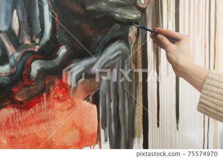 Young man paint abstract painting on canvas in art studio Young man paint abstract painting on canvas in art studio 75574970