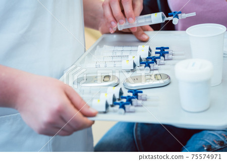 Nurse carrying test tubes for pulmonary disease filled with air Nurse carrying test tubes for pulmonary disease filled with air 75574971