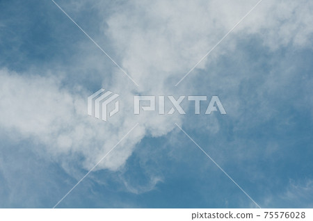 Reflections warm rays setting sun, swirls strong gust wind, outdoors. Bright blue sky, white translucent feathery clouds. Reflections warm rays setting sun, swirls strong gust wind, outdoors. Bright blue sky, white translucent feathery clouds. 75576028