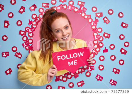 Beautiful redhead female holding FOLLOW ME sign, ask to be more active in Internet, send likes and messages Beautiful redhead female holding FOLLOW ME sign, ask to be more active in Internet, send likes and messages 75577859