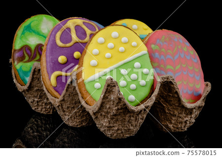 Easter decorated baked eggs, cookies on a black background 75578015