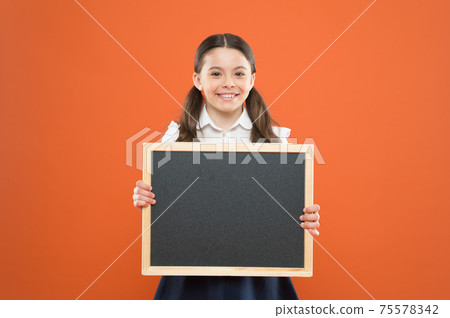 happy small school girl with chalkboard. blackboard happy small school girl with chalkboard. blackboard 75578342