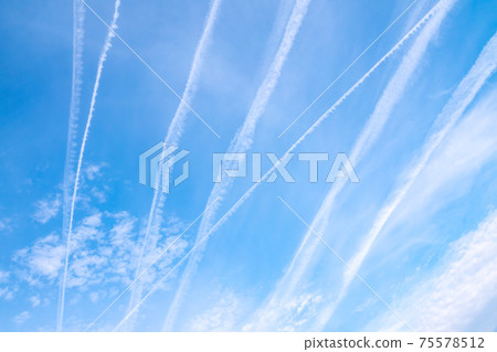 Blue sky with airplane trails and clouds. Blue sky with airplane trails and clouds. 75578512