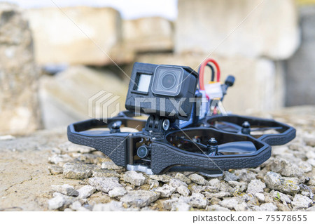 A Brand-New Modern Cinewhoop Iflight Protek 35 with GoPro Action Camera on Board Outdoors in the Grass A Brand-New Modern Cinewhoop Iflight Protek 35 with GoPro Action Camera on Board Outdoors in the Grass 75578655