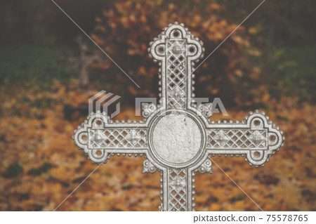 Creepy frosted vintage orthodox cross in the old autumn cemetery Creepy frosted vintage orthodox cross in the old autumn cemetery 75578765