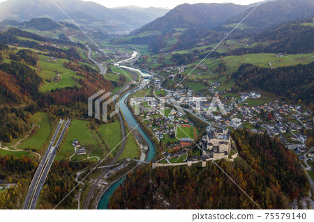 Aerial view of green meadows with villages and forest in austrian Alps mountains. 75579140