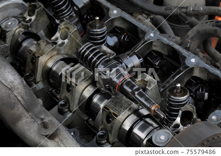 Closeup of modern diesel engine cylinder head with injectors 75579486