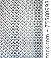 Old metal steel springy mesh with chain link on a beige background 75580998