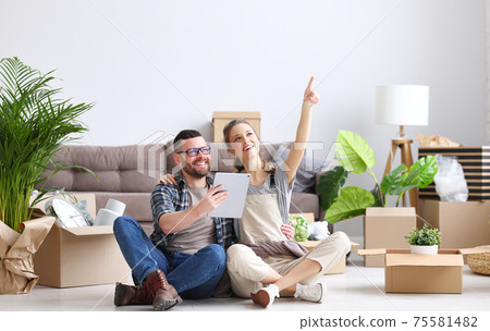 Happy couple during moving in new apartment 75581482