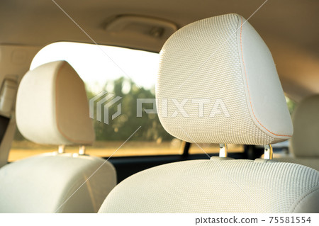 Closeup detail of light beige car headrests. Closeup detail of light beige car headrests. 75581554