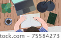 A man who spreads his computer and notebook on his desk and works 75584273
