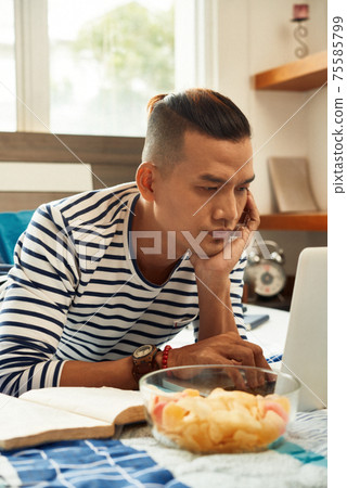 Student watching educational video Student watching educational video 75585799