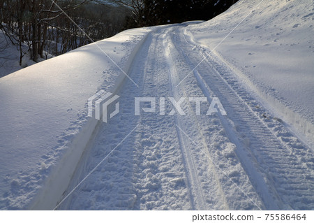 Traces of a snow vehicle on a closed road, Tadami Town, Fukushima Prefecture 75586464