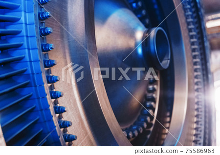 The rotor disk with the blades of a turbojet gas turbine engine with a blue glow. The rotor disk with the blades of a turbojet gas turbine engine with a blue glow. 75586963