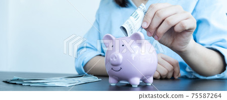 Women's hands hold dollars and put piggy banks to save money, expand successful businesses, and save for retirement 75587264