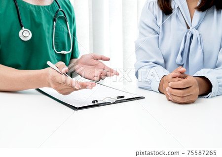 Male doctors explain and recommend treatment after a female patient meets a doctor and receives results regarding illness problems. Medical and health care concepts 75587265