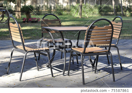 Set of furniture, Table and chairs for outdoor party. Dining table and chairs in the back yard. Nobody.  Set of furniture, Table and chairs for outdoor party. Dining table and chairs in the back yard. Nobody.  75587861