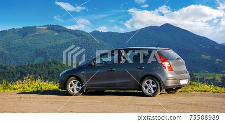mizhhirya, ukraine - AUG 08, 2020: car on the concrete parking on top of the mountain in morning light. travel countryside concept. beautiful nature scenery views in summer with clouds on the blue sky mizhhirya, ukraine - AUG 08, 2020: car on the concrete parking on top of the mountain in morning light. travel countryside concept. beautiful nature scenery views in summer with clouds on the blue sky 75588989
