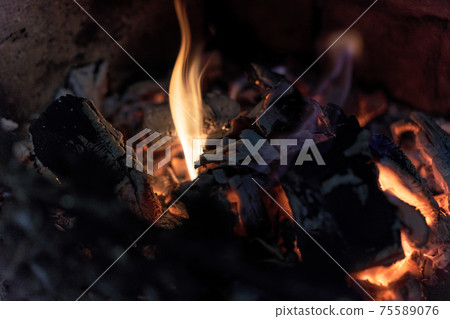 actively smoldering embers of fire and a little flame 75589076