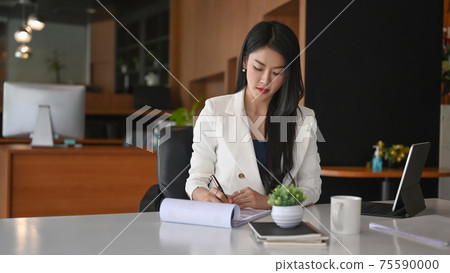 Successful businesswoman concentrate working in modern office. Successful businesswoman concentrate working in modern office. 75590000