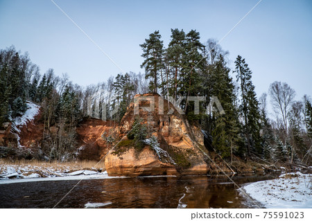 Zvartas red rock and river Amata at city Cesis in Latvia. Winter photo Zvartas red rock and river Amata at city Cesis in Latvia. Winter photo 75591023