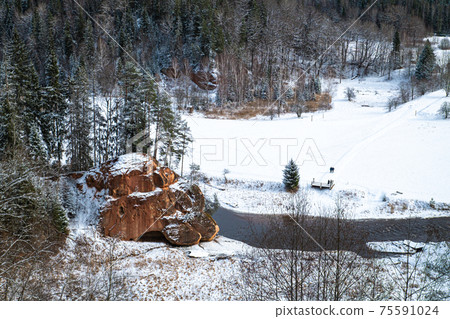 Zvartas red rock and river Amata at city Cesis in Latvia. Winter photo Zvartas red rock and river Amata at city Cesis in Latvia. Winter photo 75591024