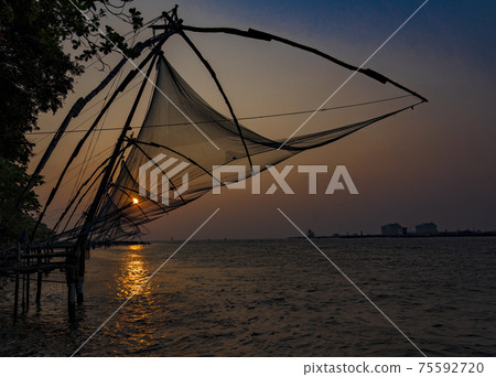 Fishing nets idle at sunset Fishing nets idle at sunset 75592720