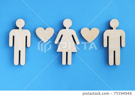 Wooden figurines of men and women with hearts on blue background 75594948